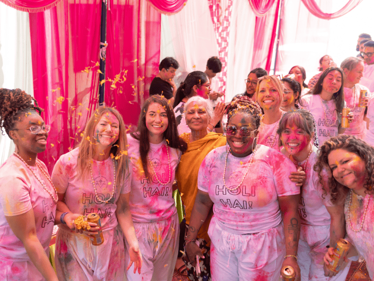 women throwing color for Holi in India on a women only tour